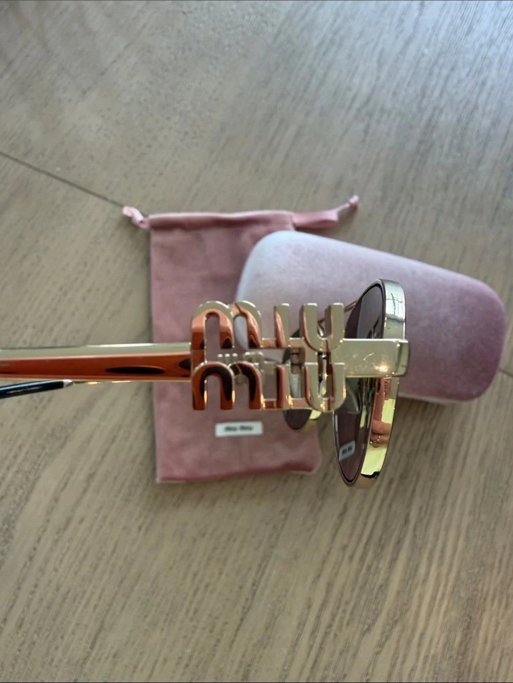 Miu Miu Gold Frame Oval Sunglasses with Dark Lenses and Pink Case/Pouch